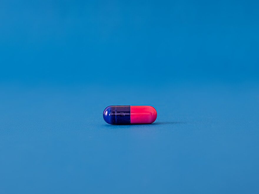 red and blue pill on blue surface